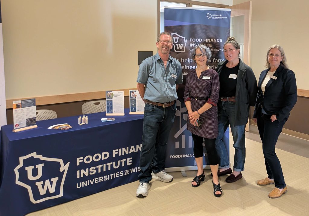 FFI team in front of banner